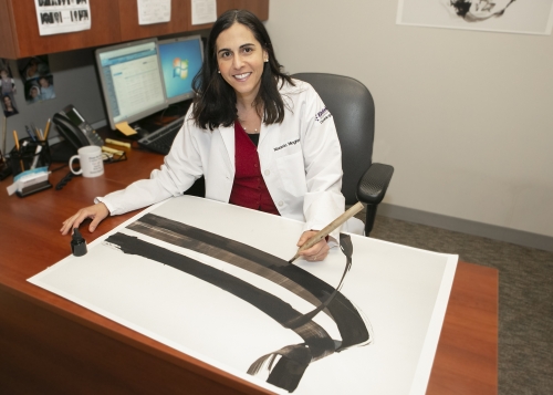 a woman doctor sits at a desk